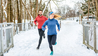 active runner couple jogging together in forest