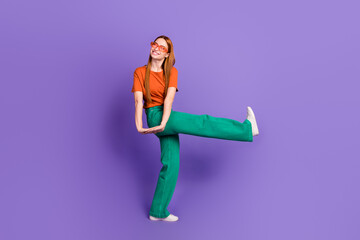 Full length photo of overjoyed nice girl wear trendy clothes dance celebrate holidays look empty space isolated on purple color background