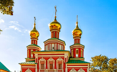 Fototapeta na wymiar The upper part of the building of the Intercession Church with domes and crosses in the Novodevichy Convent in Moscow