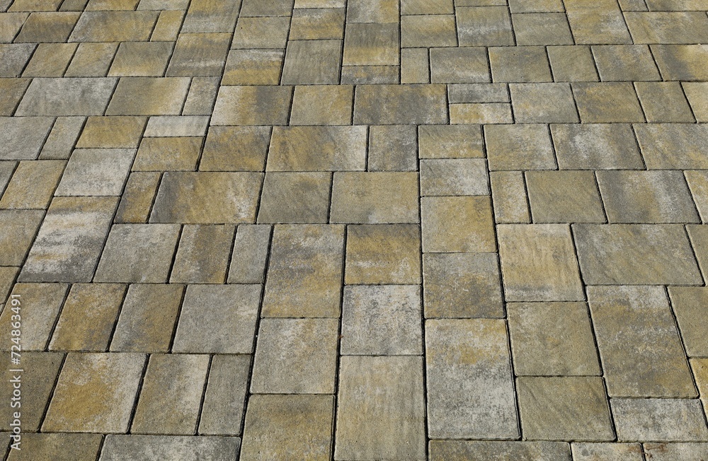 Wall mural Concrete tiles for outdoor pavements. Colors are gray and yellow greenish. Background and texture.