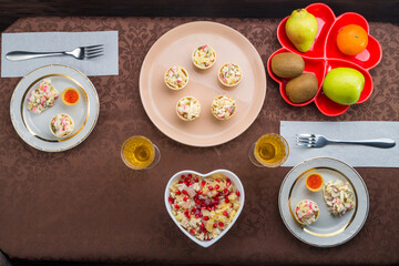 Sparkling champagne in glasses on the table, salad in tartlets, buffet table, top view