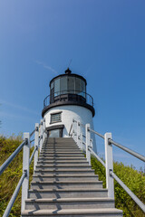 Owls Head Lighthouse in Rockland Maine USA on a clear sunny summer day with blue sky
