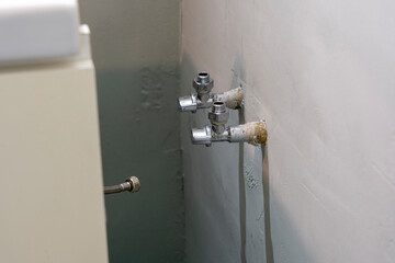 Taps and Twisted Adapters in a Bathroom, Readied to Connect Water to the Sink.