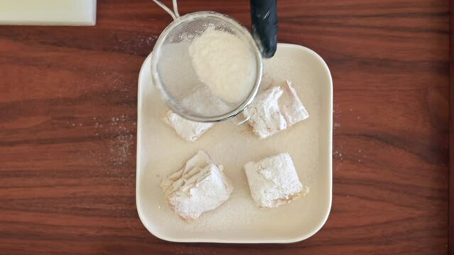 Freshly baked kurt pastry is sprinkled with powdered sugar