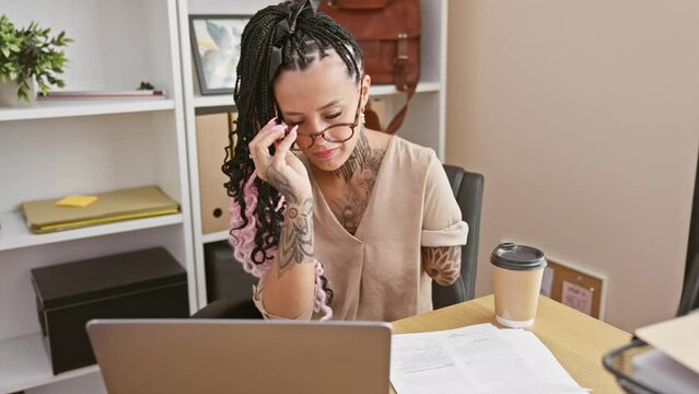 Elegant hispanic amputee woman worker, bossing her business world from an office, wearing glasses to ace paperwork