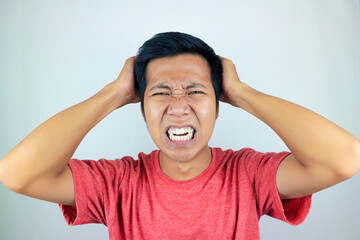 funny facial expression of stressed asian man holding his head, isolated on white background