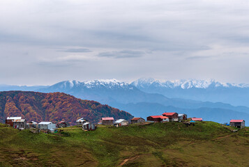 Plateau houses and snowy mountains