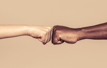Friendship, team, good work. Closeup friends giving fist bump to each other. Black african american race male and woman hands giving a fist bump, multiracial diversity, immigration concept - obrazy, fototapety, plakaty