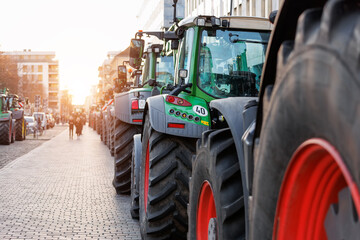 Farmers union protest strike against government Policy in Germany Europe. Tractors vehicles blocks city road traffic. Agriculture farm machines Magdeburg central Domplatz square