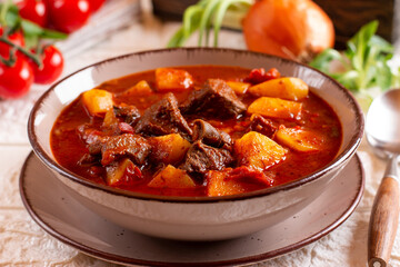 Goulash with potatoes and vegetables seasoned with paprika and other spices. Perfect for recipe, menu book, or any cooking contents. Typical Czech food. Hungarian cuisine.