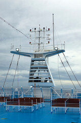 Radars on the top cruise liner deck. Close-up view of navigation equipment, antennas and searchlights on the deckhouse of an ocean liner. Control navigation set antennas at the top of the cruise ship