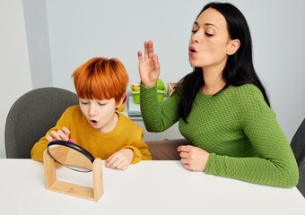 Speech and language therapist with a young male patient in pediatric speech therapy