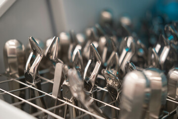 Dentist's instruments in the sterilizer. Various iron tools used in dentistry to work with patients.