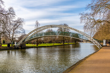 A view up the River Great Ouse towards the suspension bridge in Bedford, UK on a bright sunny day