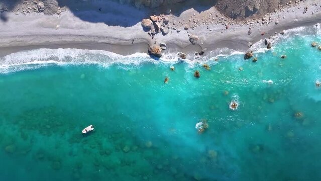 Aerial top down view of the beautiful beach at Lalaria, Skiathos island, Sporades, Greece, with turquoise shining sea
