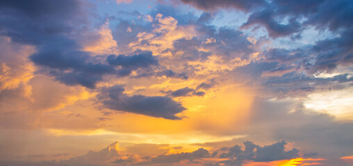Beautiful cloudscape and dramatic sunset with colorful clouds lit by the sun.