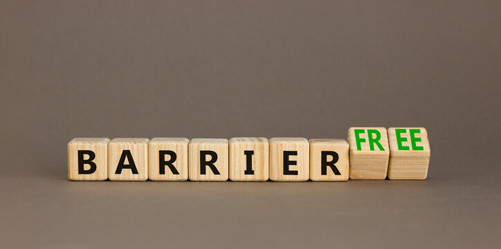 Barrier free symbol. Concept words Barrier free on beautiful wooden cubes. Beautiful grey table grey background. Business, inclusivity and barrier free concept. Copy space.