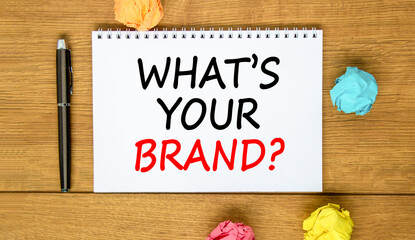Fototapeta premium Branding what is your brand symbol. Concept words What is your brand on beautiful white note. Beautiful wooden background. Black pen. Paper. Business branding what is your brand concept. Copy space.