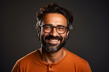 Fototapeta premium Portrait of a successful smiling bearded man in glasses on an dark background