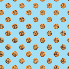 Cookie pattern with chocolate drops on blue background. Cookie background. Top view, flat lay