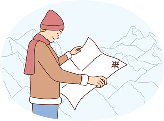 Male traveler with paper map navigate in mountains. Man tourist hiking or trekking in highland landscape. Travel and tourism.
