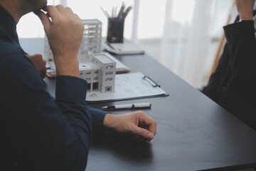 Real estate agent and Sales manager team analysis pricing of rental lease contract of sale purchase agreement, concerning mortgage loan offer for and house insurance.