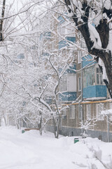 heavy snowfall in the city outside the window. Snow and wind blizzard in winter