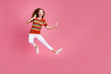 Full length photo of active excited person jump kick fight empty space isolated on pink color background