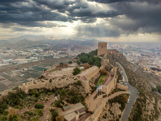 Aerial view of Lorca castle in Southern Spain covering the entire hilltop with large square keep