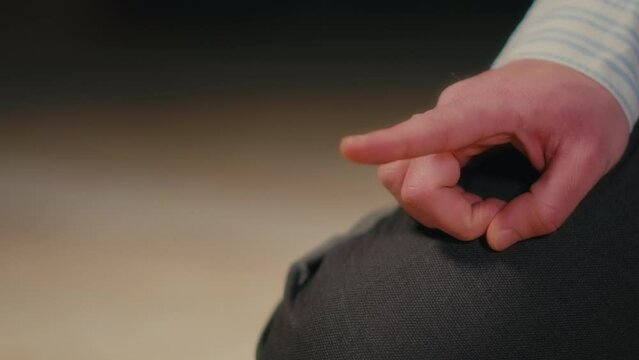 Close-up of a White Man Raising His Right Index Finger During an Islamic Prayer