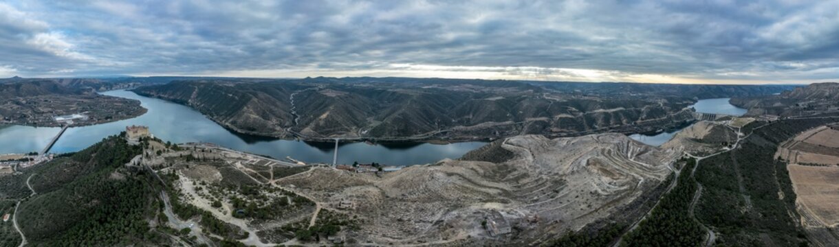 Mequinenza castle panoramic aerial view above the riba roja reservoir in Aragon Spain with dramatic colorful sky