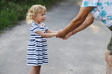 Child with grandmother holding hand. Selective focus.