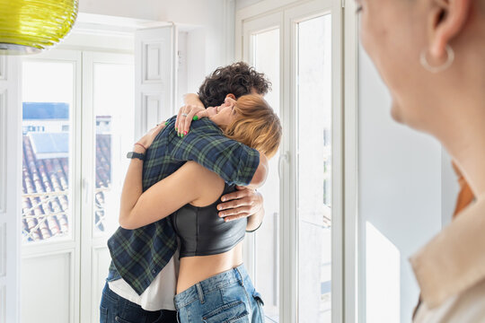 Happy couple hugging each other at home - Powered by Adobe