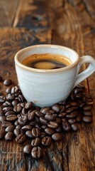 Close-up image of a cup of coffee on a wooden table scattered with coffee beans