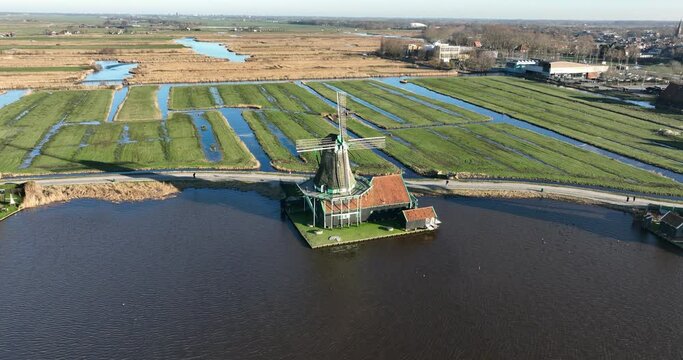 Zaanse Schans Molen 'De Kat', Historic windmill n the dutch polder, touristic attraction destination. Dutch heritage and culture. Birds eye aerial drone view.