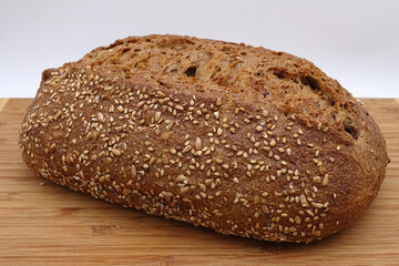 freshly baked bread with various grains on a white and red chequered cloth