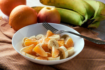 Fruit salad, orange, banana and apple