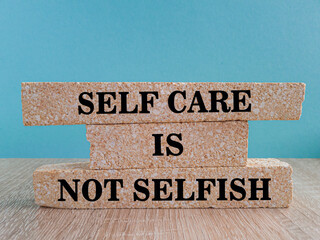 Self care is not selfish symbol. Concept words Self care is not selfish on brick blocks. Beautiful...