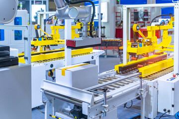cardboard box of product packaging is moving on conveyor belt of automatic packing machine in the...