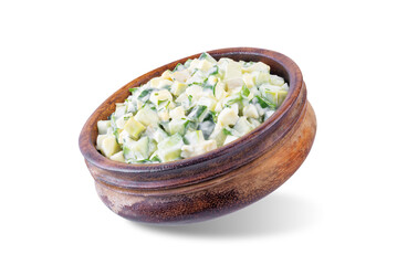 Egg cucumber avocado salad with mayonnaise sauce in a bowl on a white isolated background