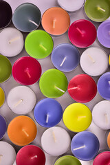 Many candles of different colors on a flat surface. Flat lei.
