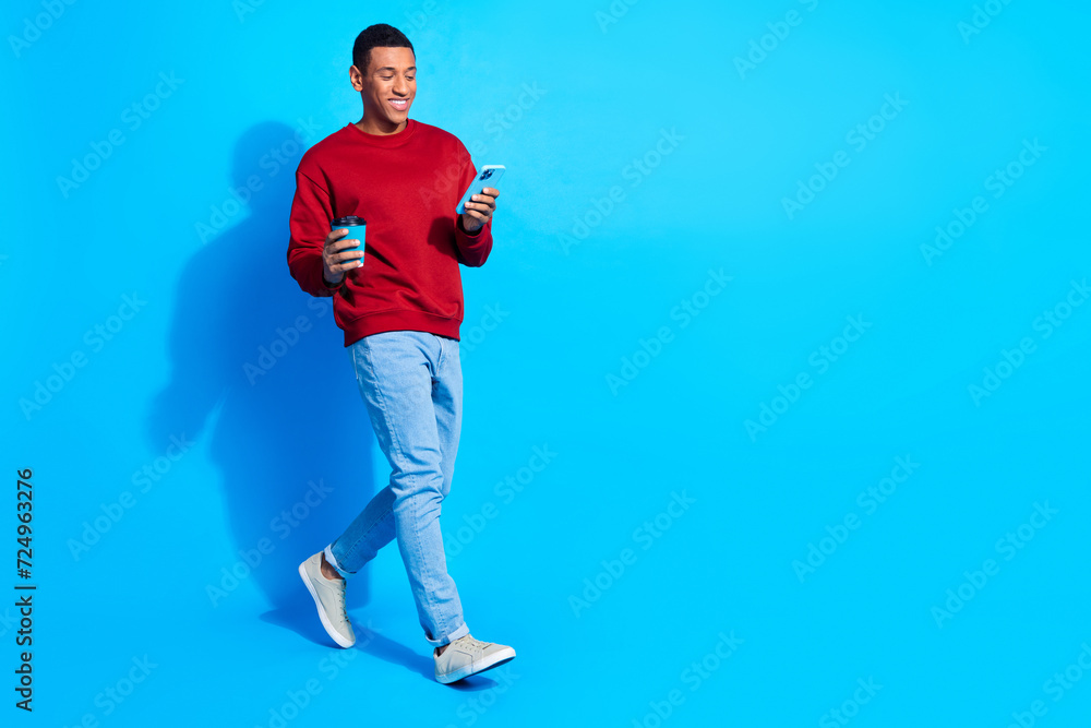 Poster full size profile portrait of nice person hold coffee use smart phone walk empty space isolated on b