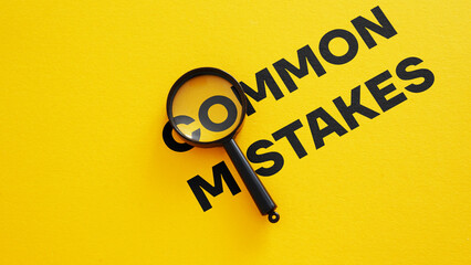 Common mistakes are shown using the photo of magnifying glass - obrazy, fototapety, plakaty