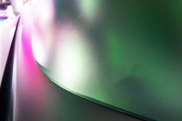 Abstract background with purple and green curved shapes.