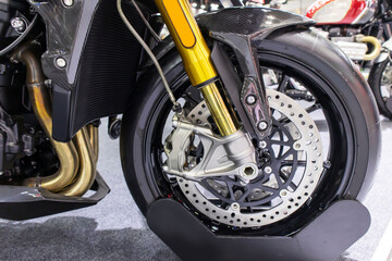 Disc brakes on a motorcycle up close alloy wheels for motorcycles robust steel wheel arches. Tires and wheels for motorcycles in chrome. ABS on motorbikes and disc brakes are safety devices. - obrazy, fototapety, plakaty