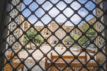 View from the window into the courtyard of an ancient madrasah in the ancient city of Bukhara in Uzbekistan in oriental style, ancient oriental buildings