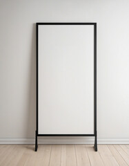 Minimalist Vertical Black Poster Frame on Light Wooden Floor Against White Wall