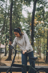 Obraz premium Happy Asian young woman walk and ride bicycle in park, street city her smiling using bike of transportation, ECO friendly, People lifestyle concept.