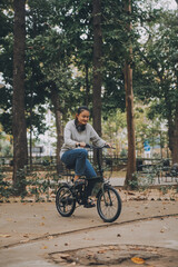 Happy Asian young woman walk and ride bicycle in park, street city her smiling using bike of transportation, ECO friendly, People lifestyle concept.