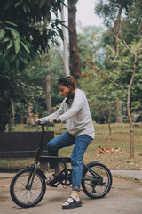 Obraz premium Happy Asian young woman walk and ride bicycle in park, street city her smiling using bike of transportation, ECO friendly, People lifestyle concept.